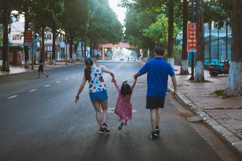 a happy family walking on the street