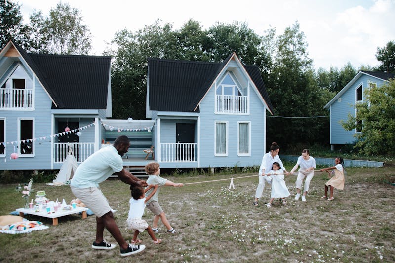 a family playing outside and having a picnic